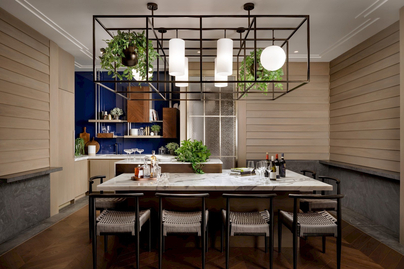 Residents in conversation at a warmly lit dining room